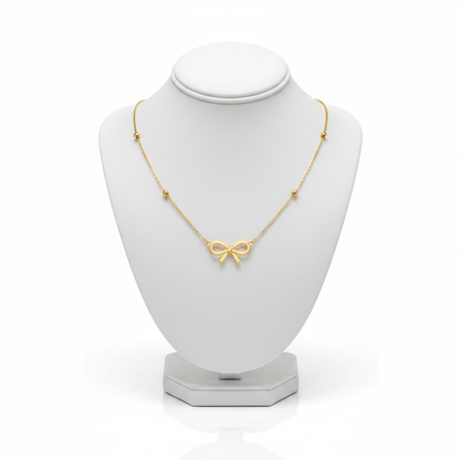 Gold Bow Pendant Necklace on White Mannequin
