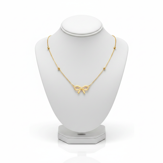 Gold Bow Pendant Necklace on White Mannequin
